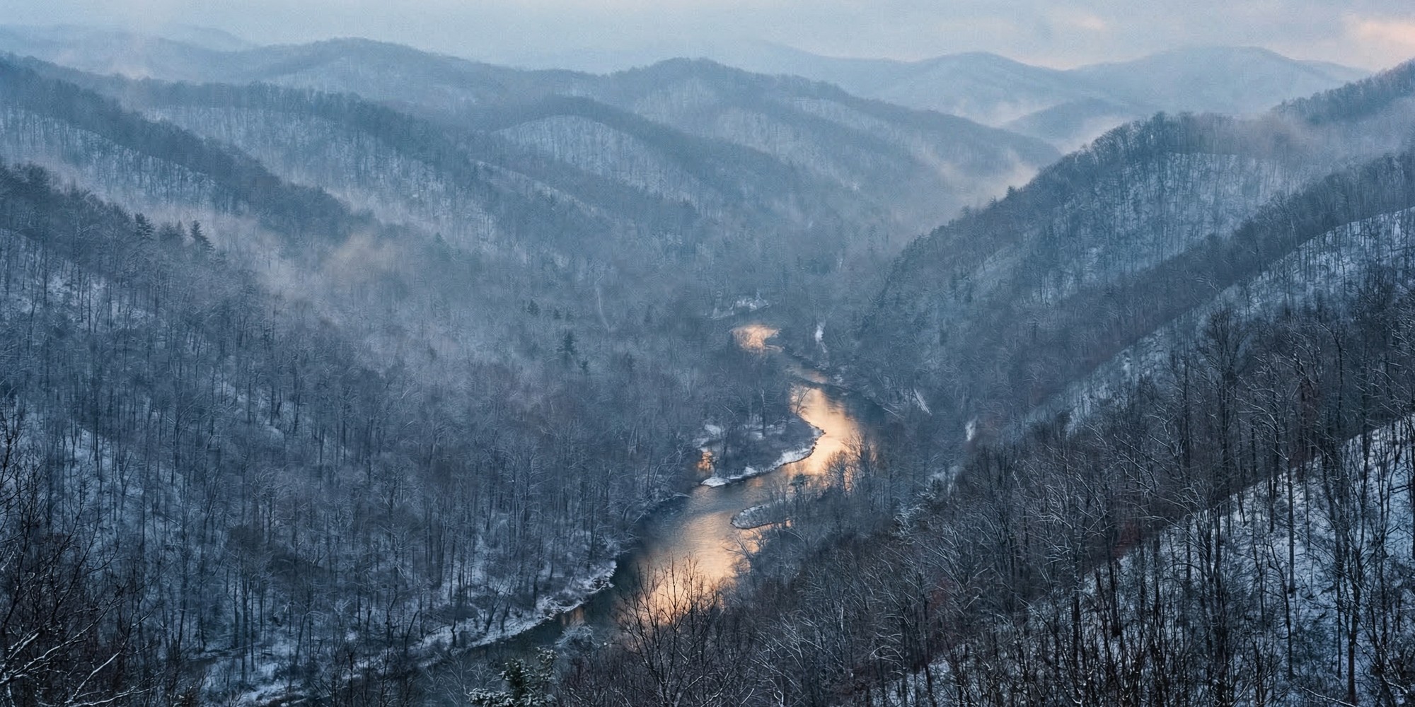 A weathered Appalachian mountain landscape at dusk, ancient ridgelines receding into mist — the ancestral homeland of the Cherokee Nation